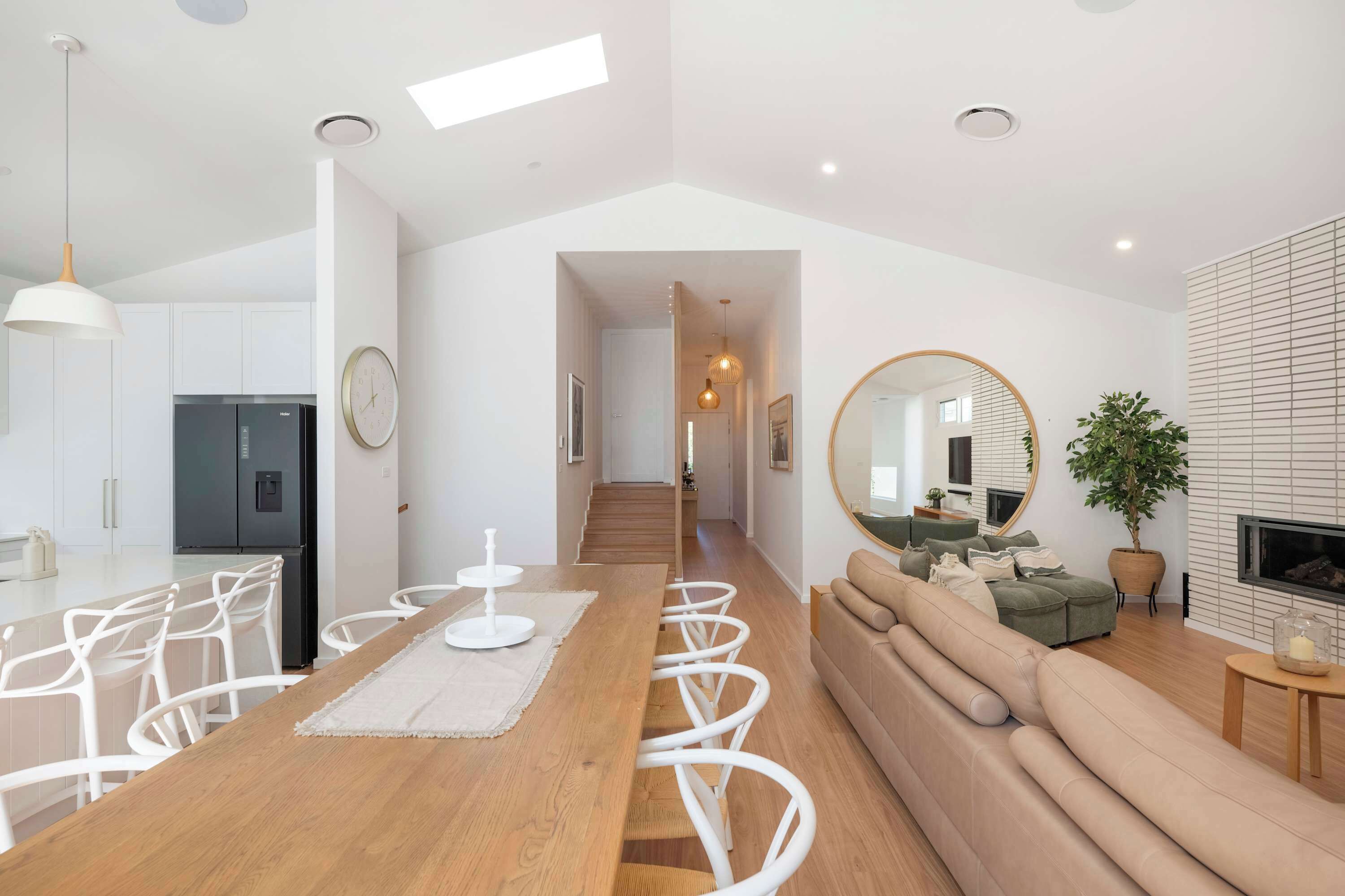 A modern living space with a dining area, kitchen, and seating area.