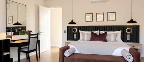 A modern bedroom with a bed, a desk, and a chair.