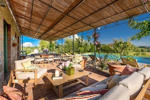 An outdoor patio with seating, a pool, and a view of the landscape. - Villa Pellegrini with breathtaking view (Montecarlo)