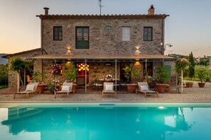 A stone house with a pool, outdoor seating, and a covered patio area. - Villa Pellegrini with breathtaking view (Montecarlo)