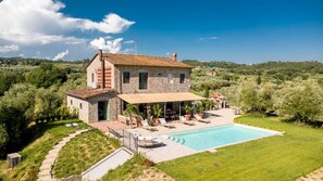 A two-story stone house with a swimming pool, outdoor seating, and a garden. - Villa Pellegrini with breathtaking view (Montecarlo)