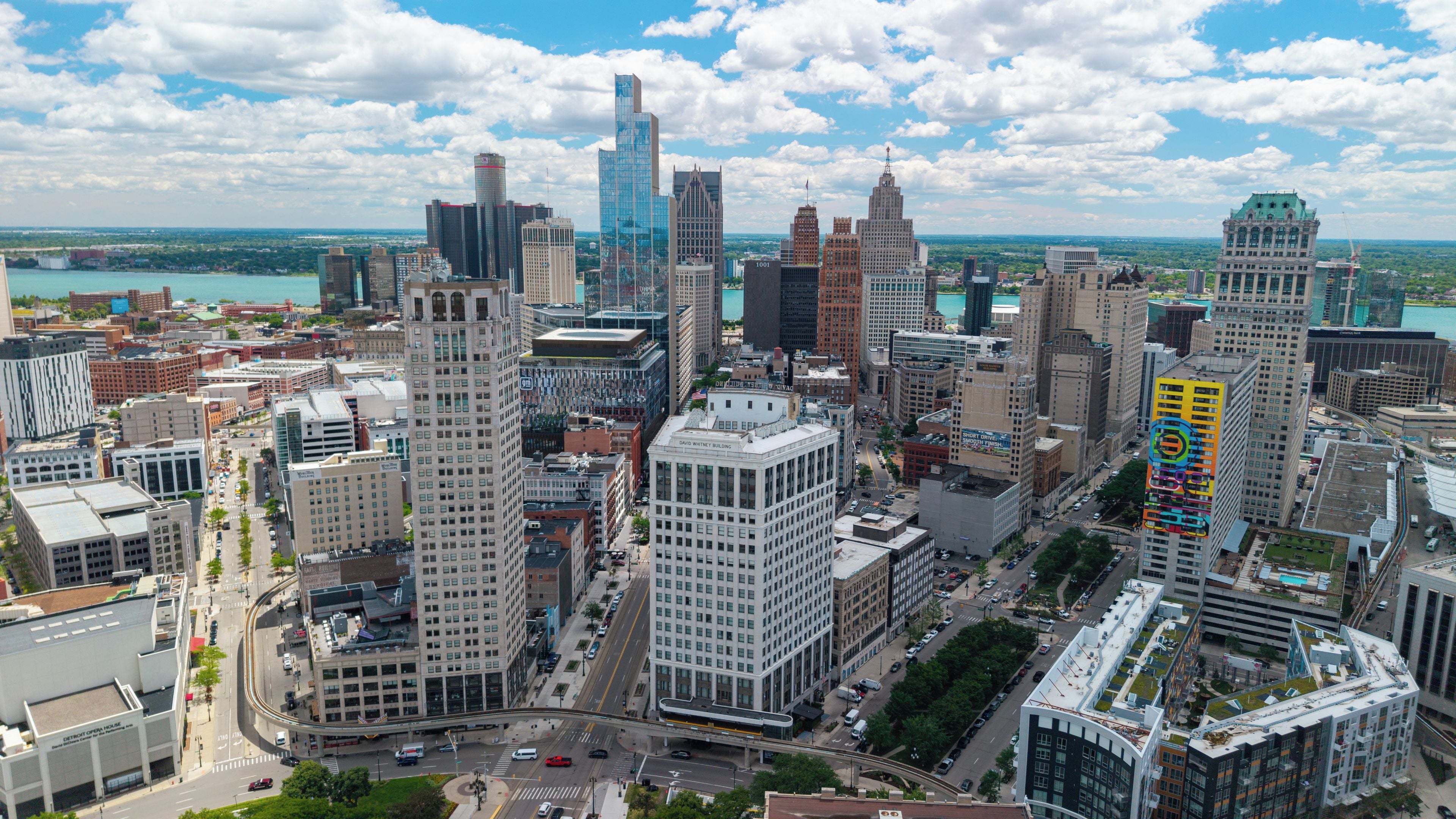 A cityscape with various buildings, including a prominent David Whitney Building.