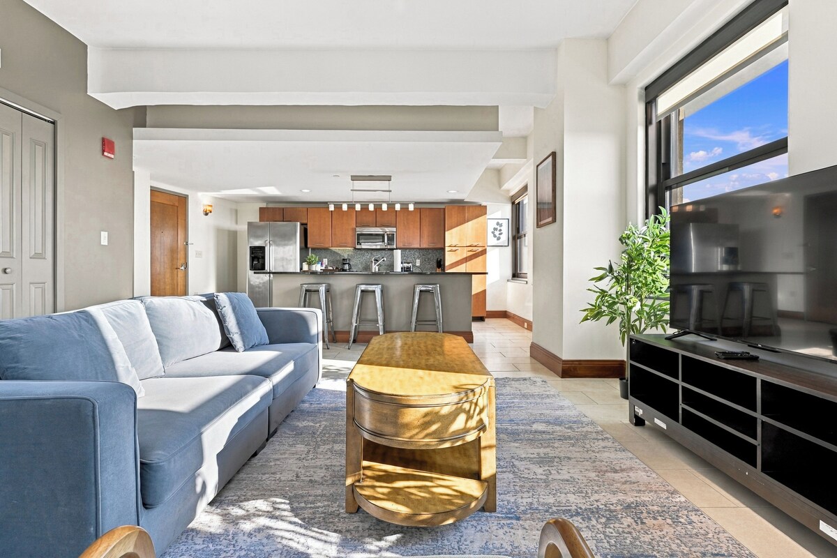 A modern living room with a sofa, a coffee table, and a TV stand.