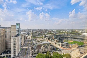 A cityscape with a prominent stadium, historic buildings, and modern architecture.