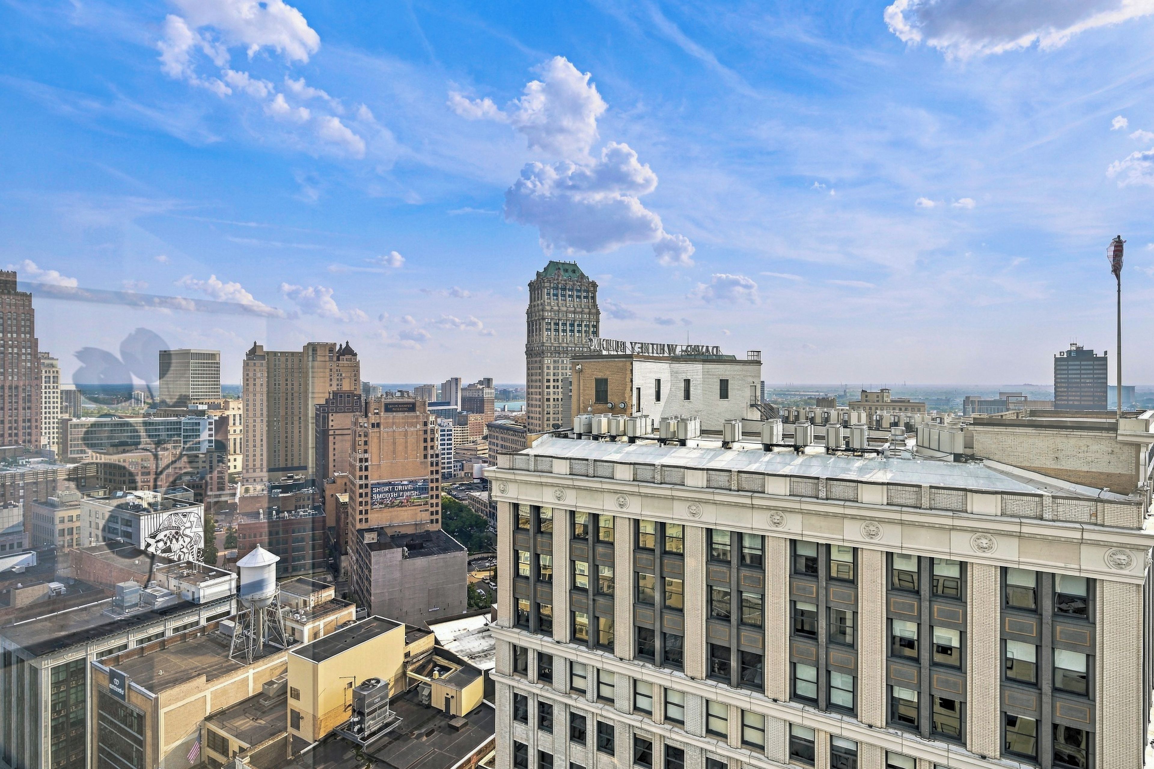 A cityscape with a prominent building featuring a large, ornate entrance and multiple windows.