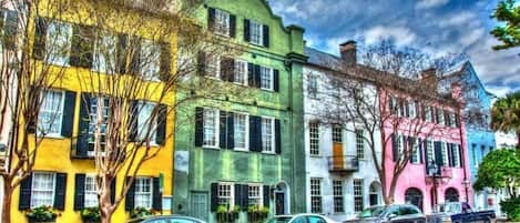 A row of colorful buildings with a street in front.