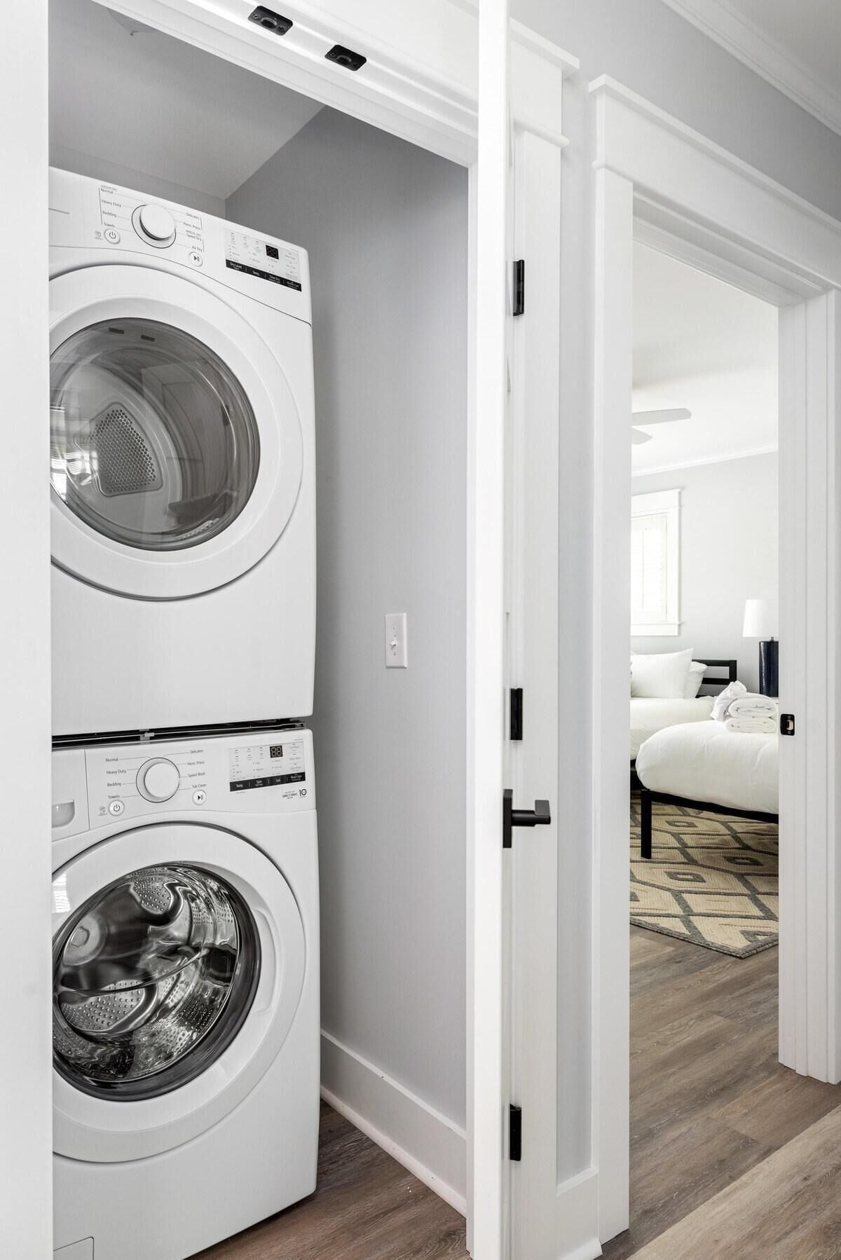A laundry room with two stacked front-loading washing machines.