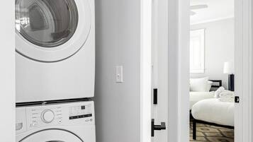 A laundry room with two stacked front-loading washing machines.