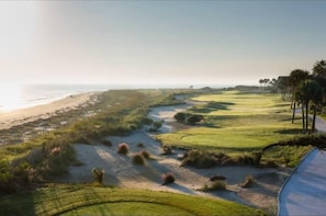 A coastal golf course with a sandy path, green fairways, and a beach in the background. - Palmetto Grove, Walk to Shem Creek, Mins to Dwt (Mount Pleasant)