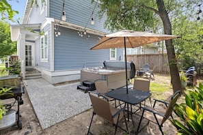 An outdoor patio with a grill, seating, and a hot tub. - Shem Creek House- 5 Mins to Dtwn & Beach Hot Tub (Mount Pleasant)