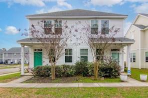 A two-story residential building with a green door and windows. - Penny Lane, Park Circle, 15m Dwtn CHS (North Charleston)
