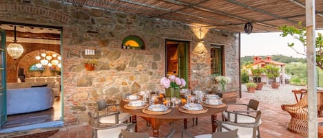 A stone building with a covered patio area.