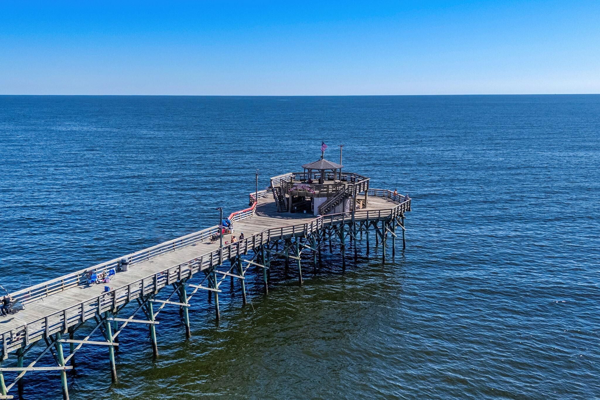 A pier extending into the water with a gazebo structure at the end.