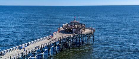 A pier extending into the water with a gazebo structure at the end.