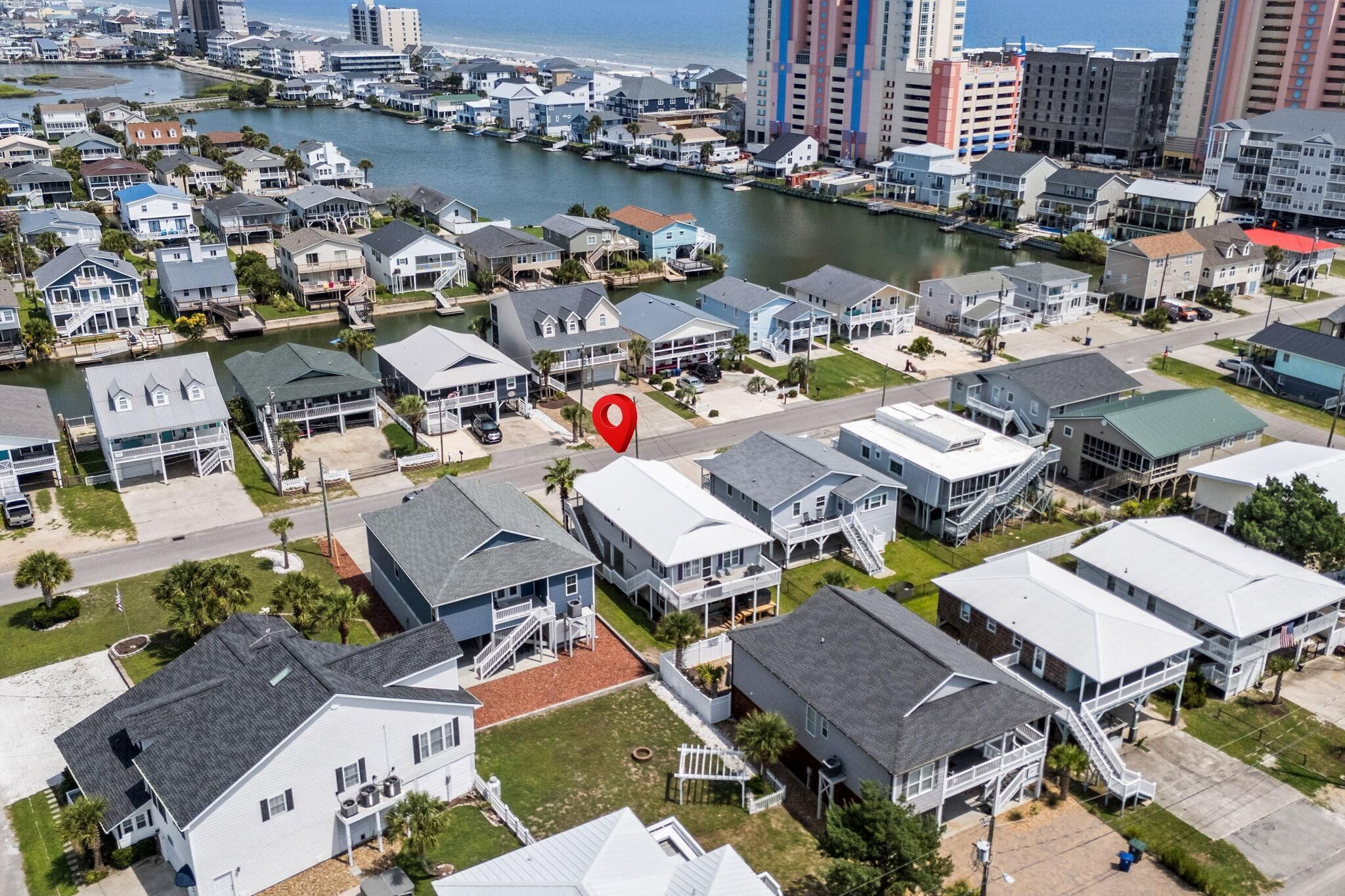 A residential area with houses, a marina, and a body of water.