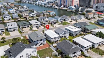 A residential area with houses, a marina, and a body of water.