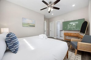 A hotel room with a bed, a ceiling fan, a TV, a desk, and a chair. - Sea Cloud-across Ocean-pet Friendly! (Myrtle Beach)