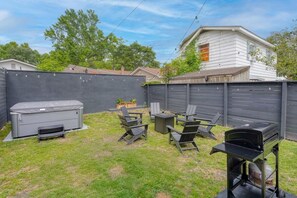 A backyard with a grill, outdoor seating, and a storage unit. - Suite Magnolia-hot Tub-pet Friendly, Mins 2 DT (Charleston)