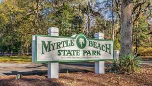 A sign for Myrtle Beach State Park with a logo and text. - The Pink Panther-ocean Side-pet Friendly (Myrtle Beach)