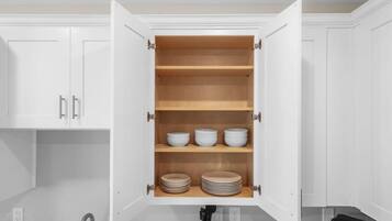 A kitchen with white cabinets, a built-in oven, and a sink.