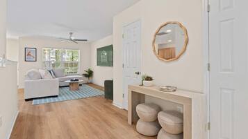 A modern living room with a sofa, coffee table, and a wooden console table with storage.