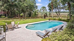 A swimming pool with lounge chairs and a wooden fence. - Boview Hall- Pool, Hot Tub-15 Mins to Kiawah (Johns Island)