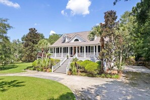 A large, single-story house with a covered porch, a central staircase, and a well-maintained lawn. - Boview Hall- Pool, Hot Tub-15 Mins to Kiawah (Johns Island)