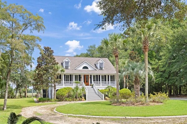 A two-story house with a wrap-around porch, a front staircase, and a well-maintained lawn. - Boview Hall- Pool, Hot Tub-15 Mins to Kiawah (Johns Island)