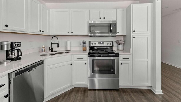 A modern kitchen with white cabinetry, stainless steel appliances, and a dishwasher. - Boho Ferry- Mins From Credit One- Pet Friendly (Charleston)