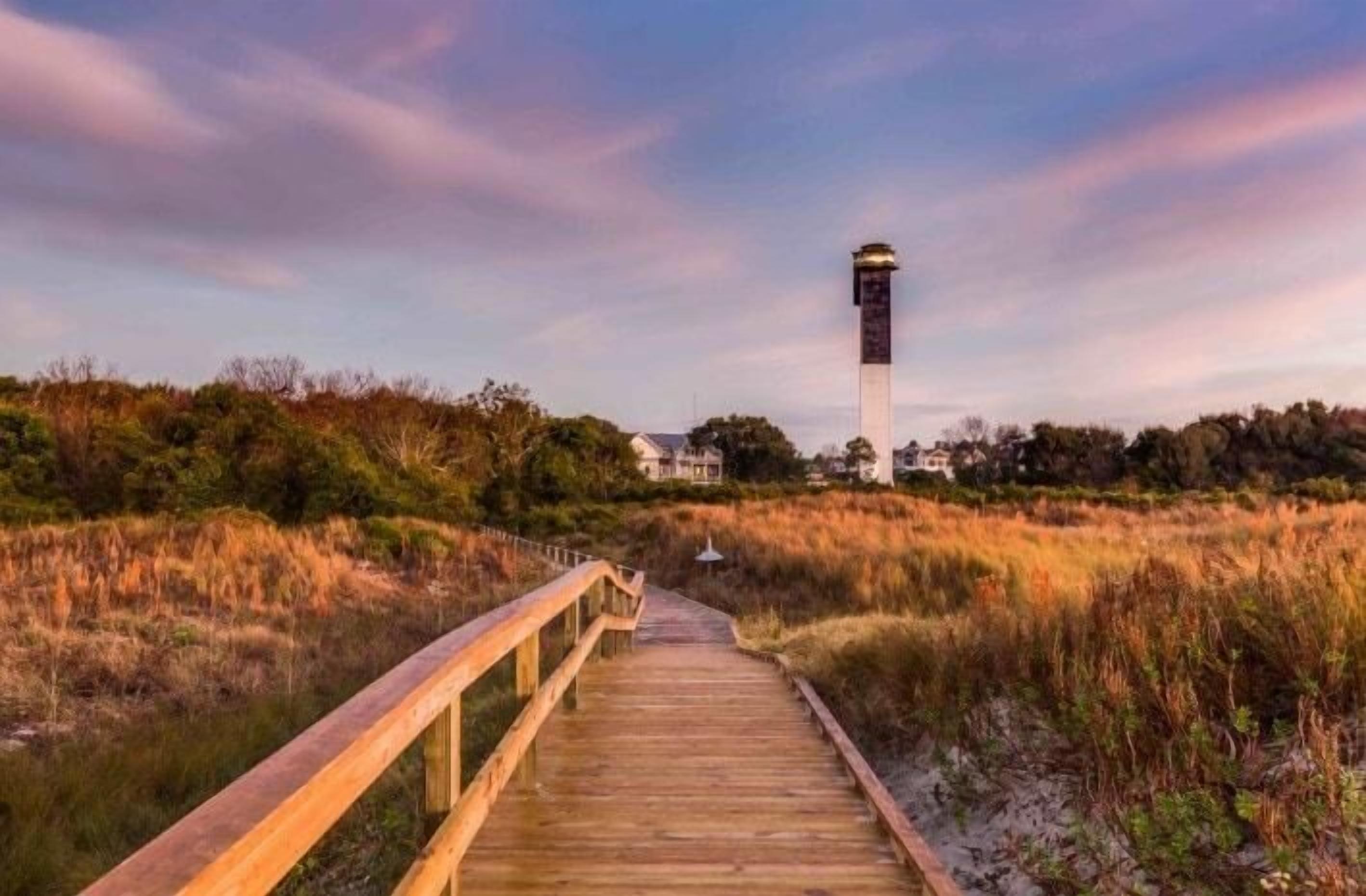 A wooden boardwalk leading to a lighthouse.