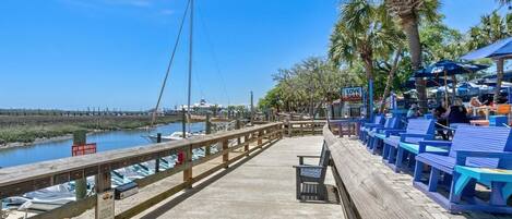A wooden pier with blue seating and a sign for 'Love Shak'.