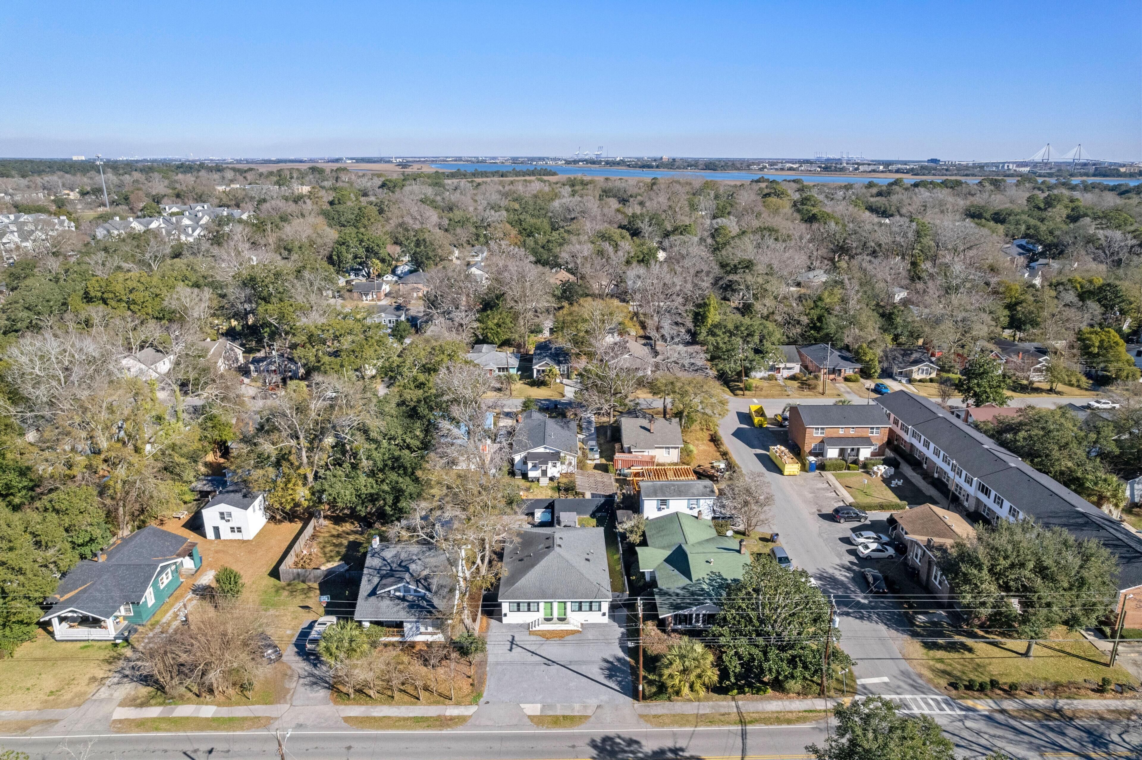 An aerial view of a residential area with houses, a parking lot, and a large building.
