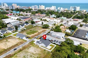 An aerial view of a residential area with houses, roads, and a large body of water in the background. - Dolce Vita - Near Beach & Boardwalk (Myrtle Beach)