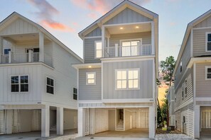 A multi-story residential building with a central entrance, balconies, and a garage. - Swell House 2.5 Blocks to Ocean Pet Friendly (Myrtle Beach)