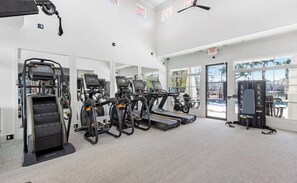 A gym with treadmills, ellipticals, and a weight bench. - Delightful 2-bedroom apartment with AC in Summerville (Summerville)
