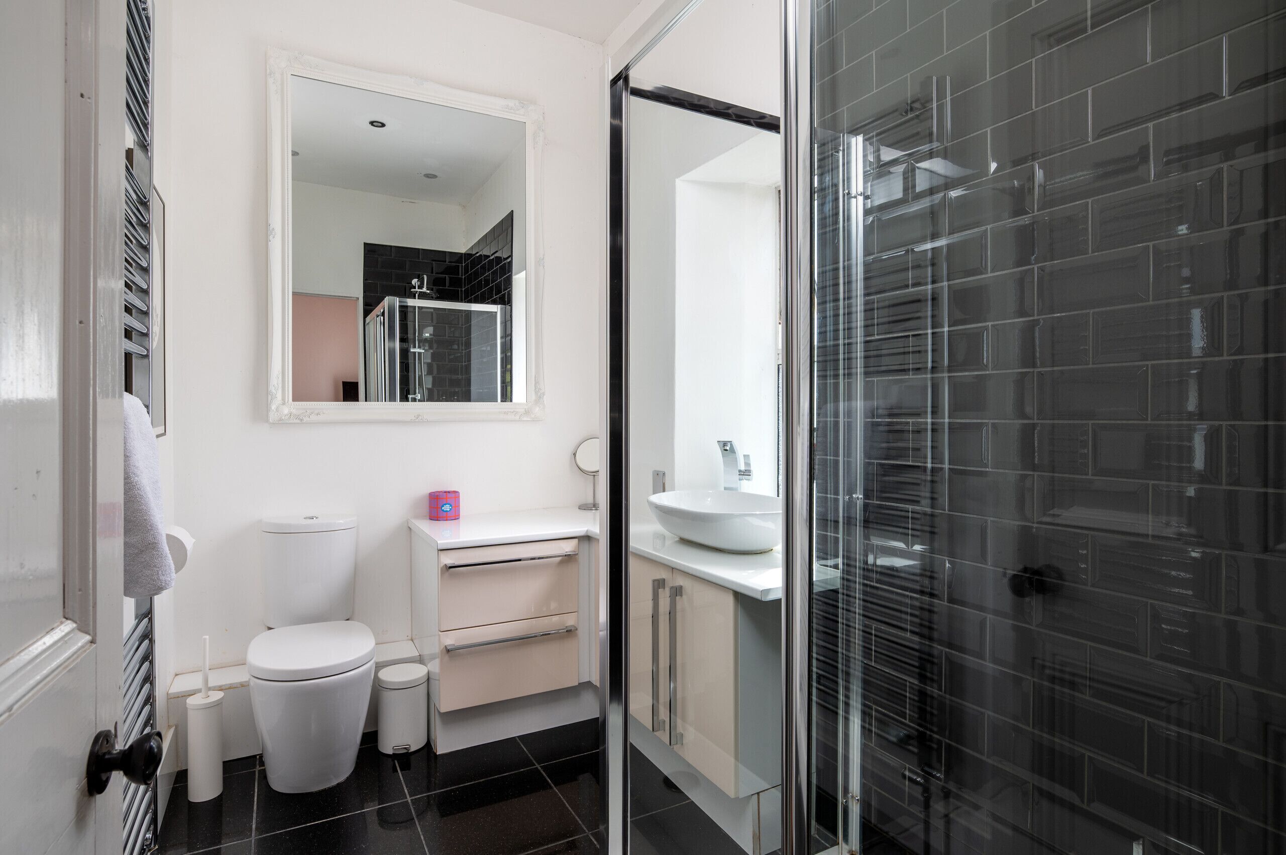 A modern bathroom with a toilet, sink, and shower.