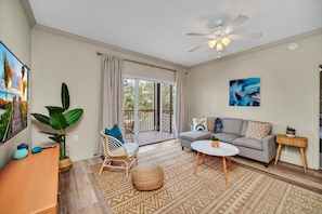 Modern living room with outdoor patio access and smart TV - Upstay Tropical Style Family Condo w Pool (Winter Garden)