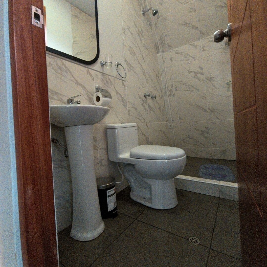 A bathroom with a sink, toilet, and shower.