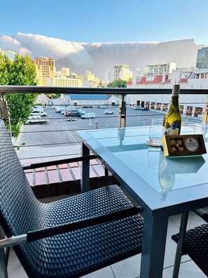 Outdoor dining - Stylish 2-Bed Apartment with Pool, Gym & Mountain Views. Walk to V&A Waterfront! (Cape Town)