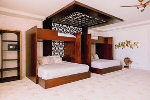 A bedroom with two wooden beds, a ladder, and a decorative ceiling structure. - Casa Playa, Las Iguanas CapCana (Punta Cana)