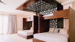 A modern bedroom with two bunk beds, a geometric ceiling design, and a large window with curtains. - Casa Playa, Las Iguanas CapCana (Punta Cana)