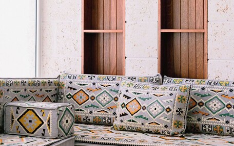 A room with a built-in bench and two wooden-framed windows.