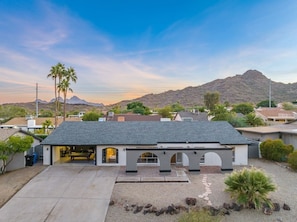 A modern house with a garage, a driveway, and a mountain in the background. - Epic PHX Fun-Game Room•Pool•Hot Tub•Mtn Views (Phoenix)