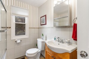 Jetted bath, hair dryer, towels, toilet paper