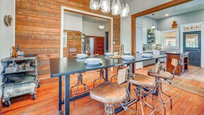 A spacious kitchen with a long island, wooden accents, and modern appliances. - Walk to the Alamodome! Quirky Gem w/ Private Patio (San Antonio)