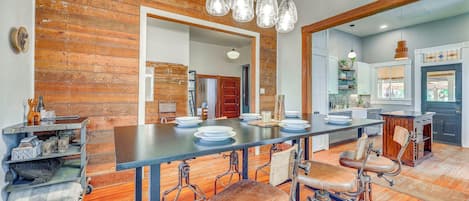 A spacious kitchen with a long island, wooden accents, and modern appliances.