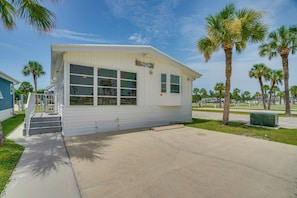 A small, single-story building with a flat roof, large windows, and a small porch. - Relaxed Resort-style Living Near Fort Myers Beach (Fort Myers)
