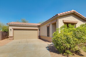 A residential building with a garage, a covered entryway, and a landscaped front yard. - Relax Poolside! Retreat 2 Mi to Santan Mtn Casino (Chandler)