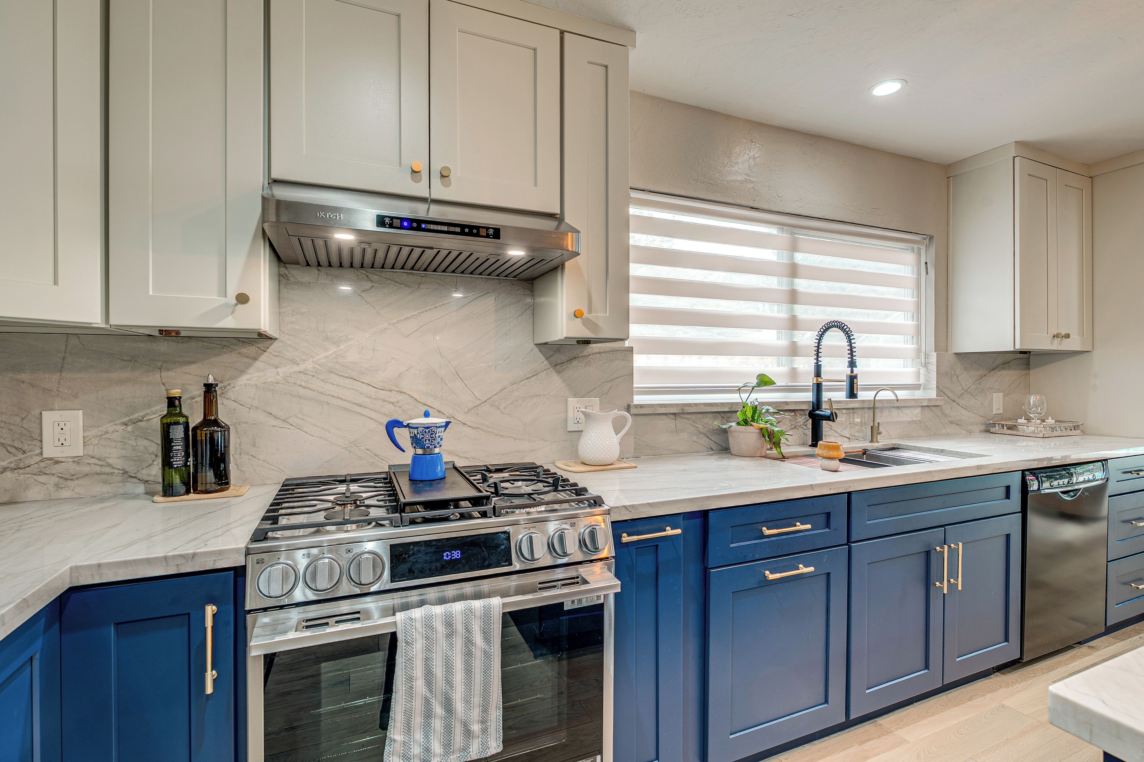 A modern kitchen with a gas stove, oven, and stainless steel dishwasher.
