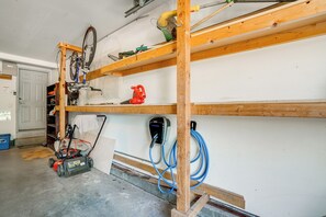 A garage with a bicycle, a chainsaw, and a power tool on shelves. - Private Deck & Hot Tub! Family Sanctuary in Frisco (Frisco)